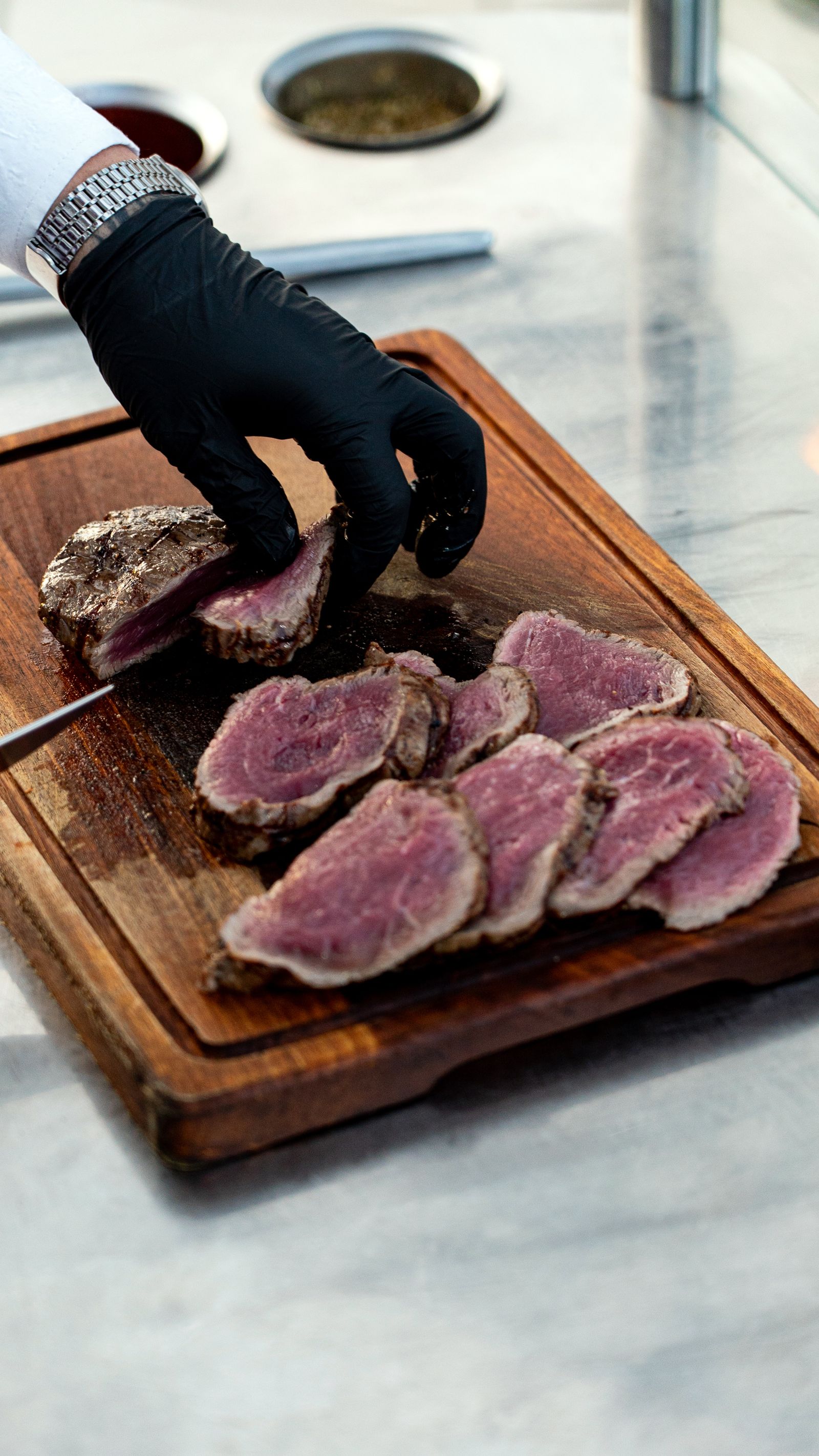 Chef slicing sous-vide beef showing even, edge-to-edge doneness